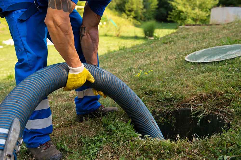 septic technician pumping a residential septic system