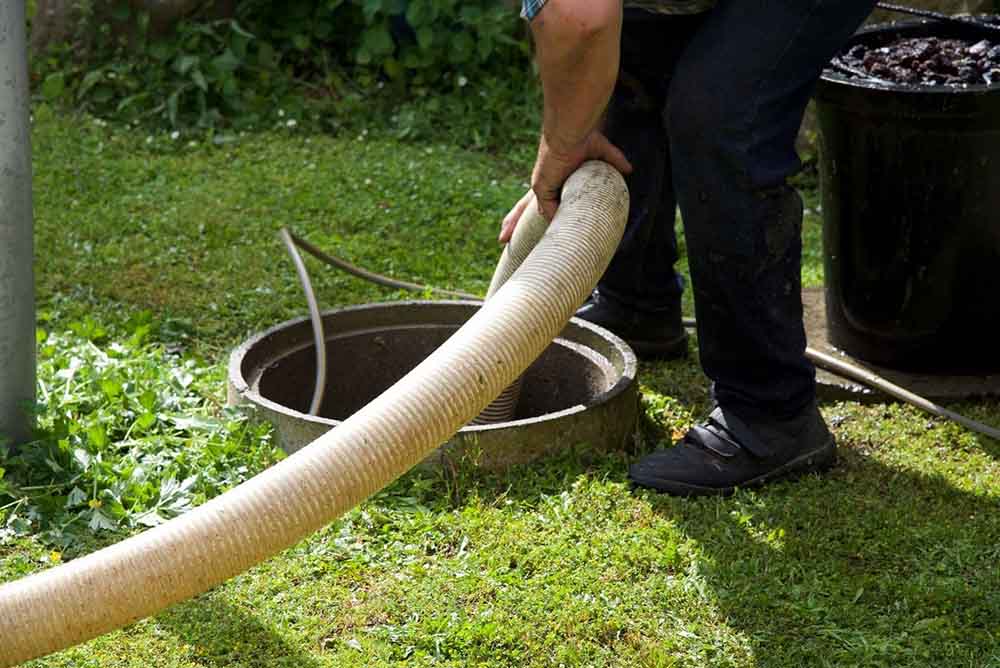 Ready Septic technician pumping a septic system