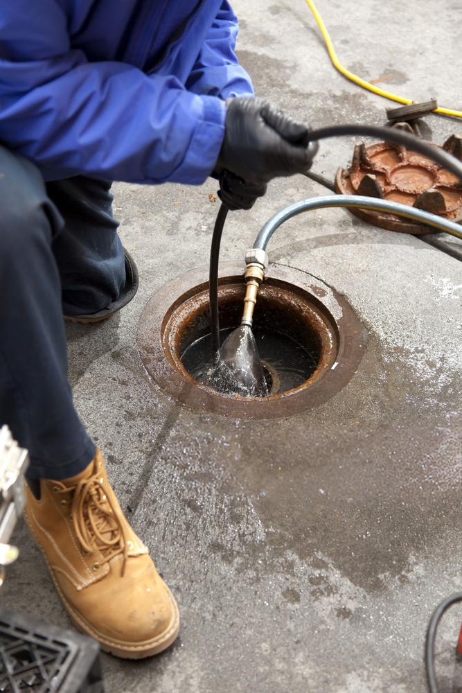 Commercial plumbers check a pipe using a camera after hydro line jetting