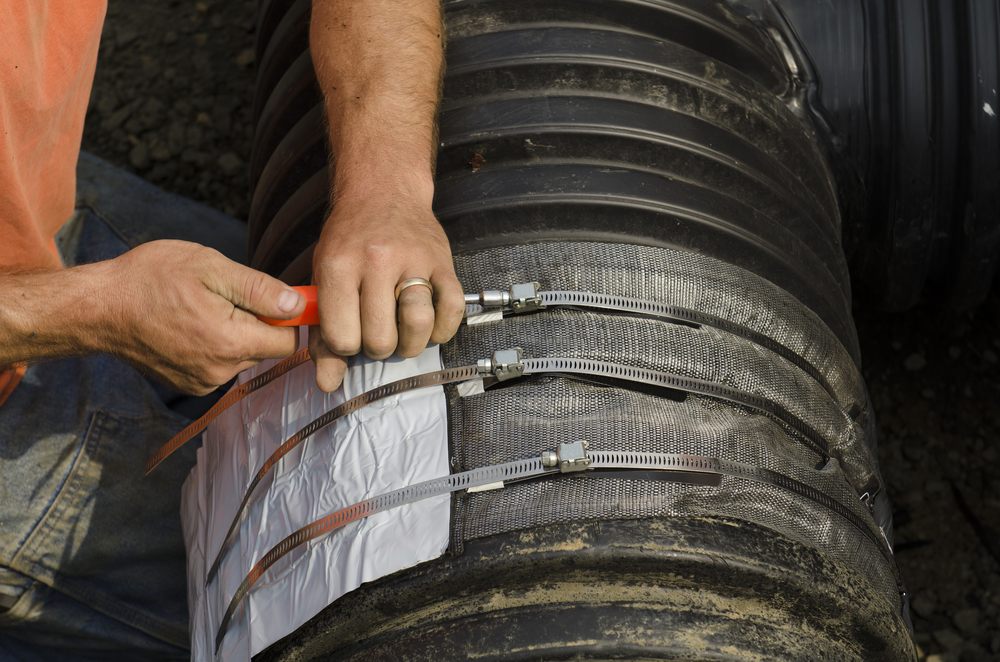 Excavation contractor uses a field repair coupler tape gasket to install a tee